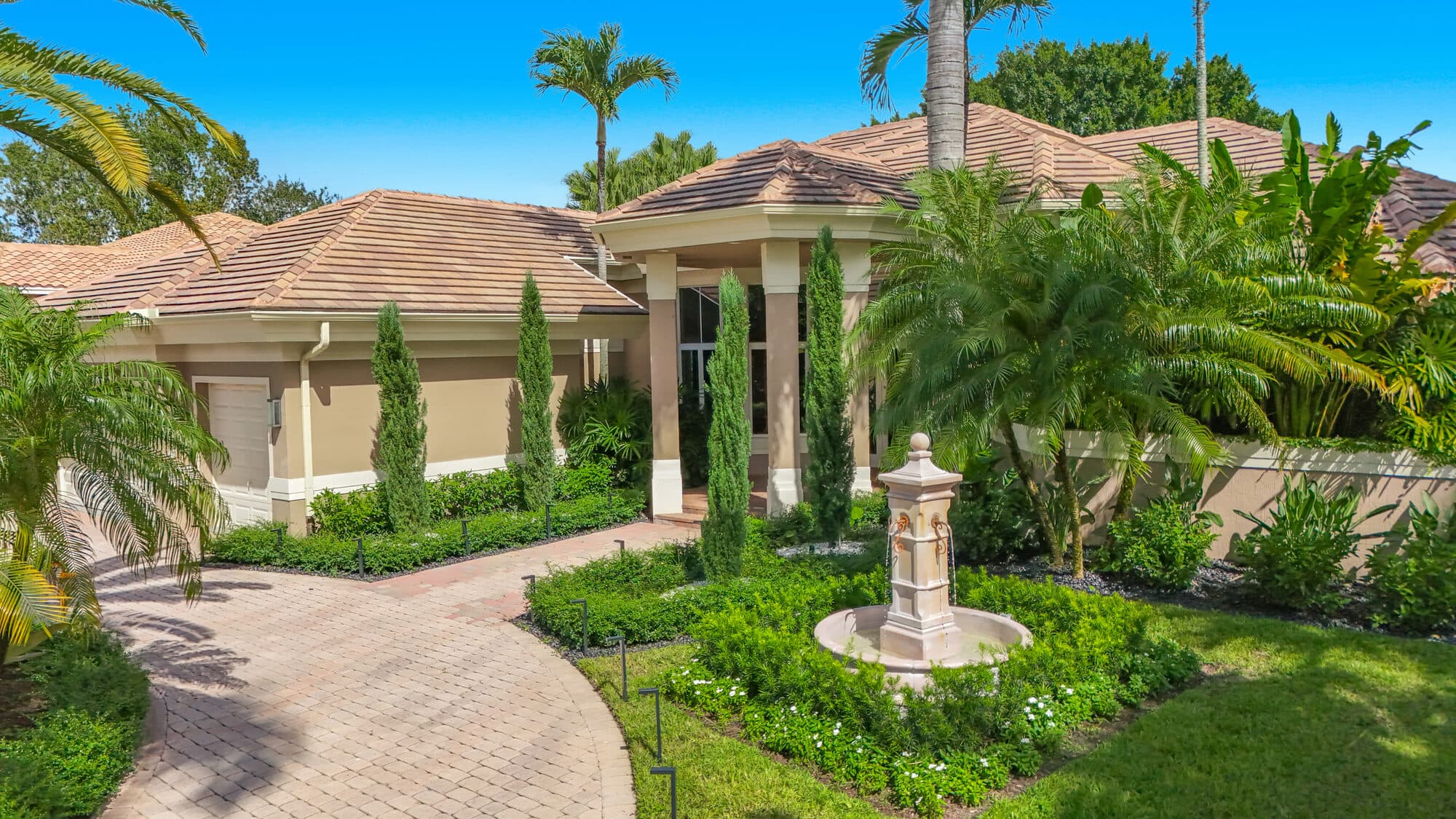 Columned front entry with the new fountain and circular paver drive
