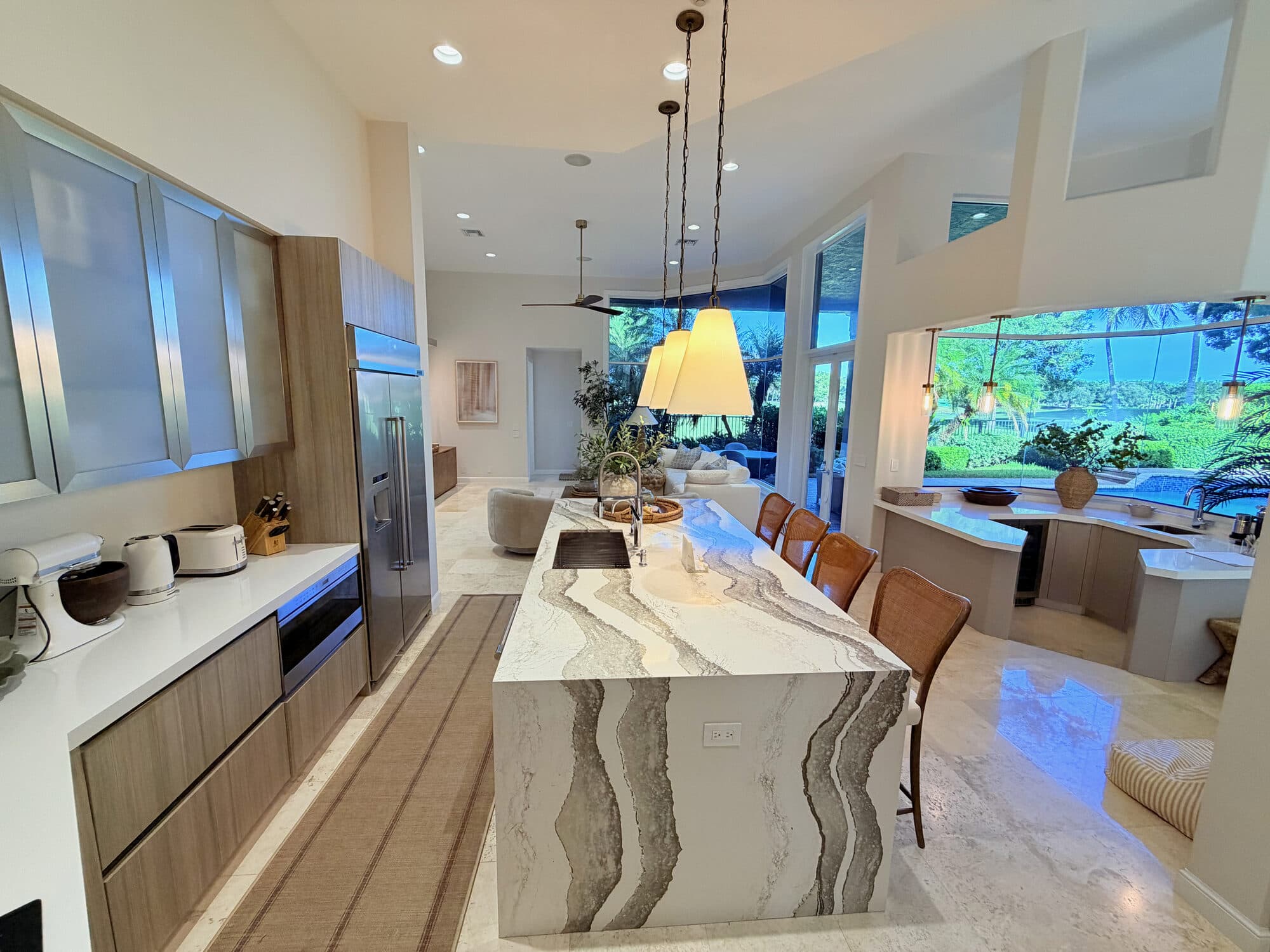 Chef's kitchen with quartz waterfall island and Wolf appliances