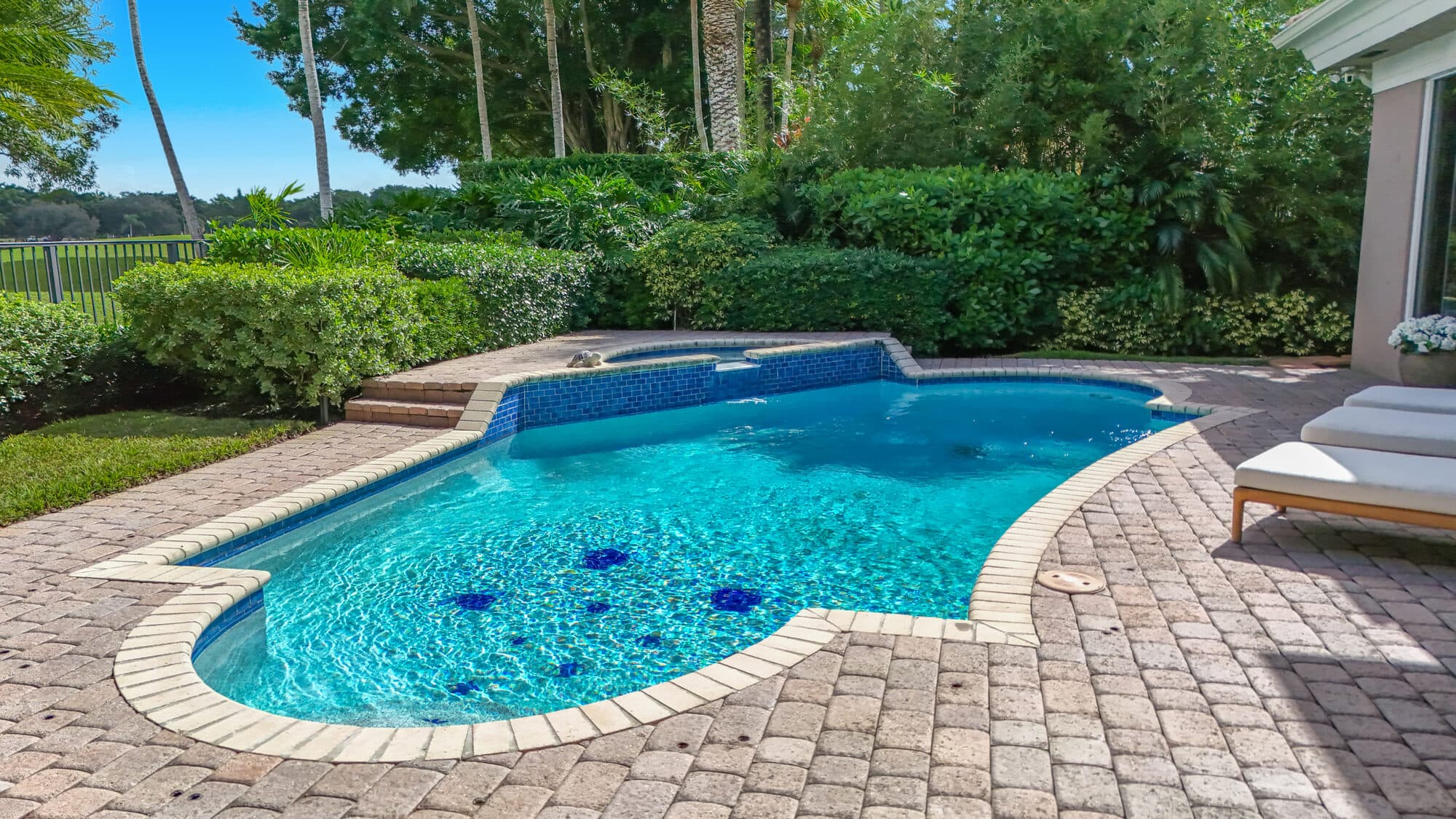 Heated pool with raised spa and paver patio