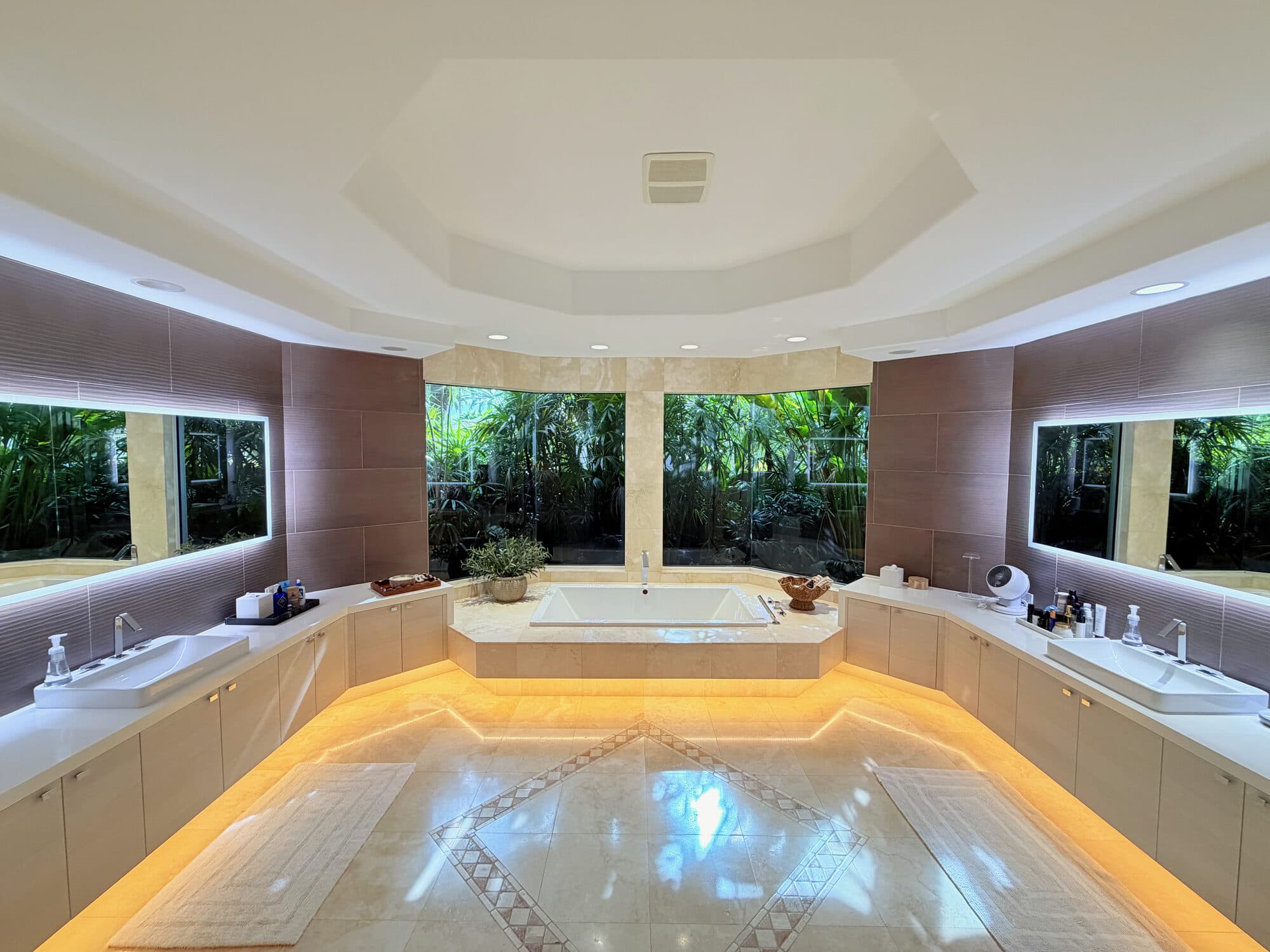 Spa-level primary bath with dual vanities and oversized Jacuzzi